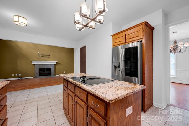5138 Foxbriar Trl, Charlotte, NC 28269 - kitchen with a chandelier, black electric stovetop, stainless steel refrigerator with ice dispenser, light tile patterned floors, and a center island