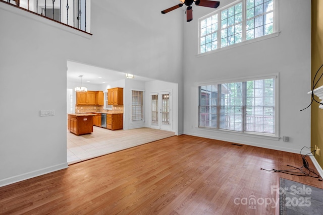 5138 Foxbriar Trl, Charlotte, NC 28269 - unfurnished living room featuring ceiling fan, a high ceiling, and light wood finished floors