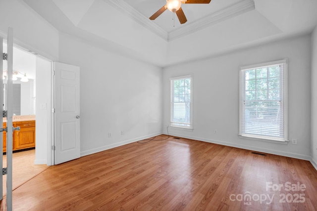 5138 Foxbriar Trl, Charlotte, NC 28269 - unfurnished bedroom with a raised ceiling, light wood-style floors, crown molding, ensuite bathroom, and a ceiling fan