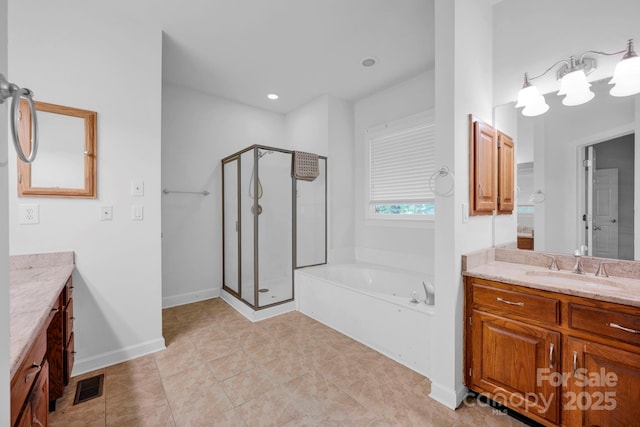 5138 Foxbriar Trl, Charlotte, NC 28269 - bathroom with vanity, a stall shower, a garden tub, and tile patterned flooring