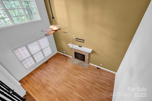 5138 Foxbriar Trl, Charlotte, NC 28269 - unfurnished living room with a fireplace, wood finished floors, and ceiling fan