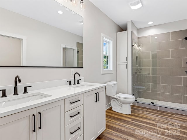 297 Bethany Dr, Mars Hill, NC 28754 - full bathroom featuring double vanity, tiled shower, wood finished floors, and recessed lighting
