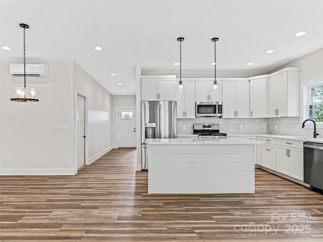 297 Bethany Dr, Mars Hill, NC 28754 - kitchen with stainless steel appliances, a wall unit AC, wood finished floors, tasteful backsplash, and recessed lighting