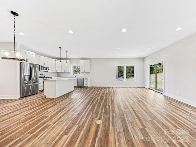297 Bethany Dr, Mars Hill, NC 28754 - unfurnished living room with light wood-style flooring, healthy amount of natural light, and recessed lighting