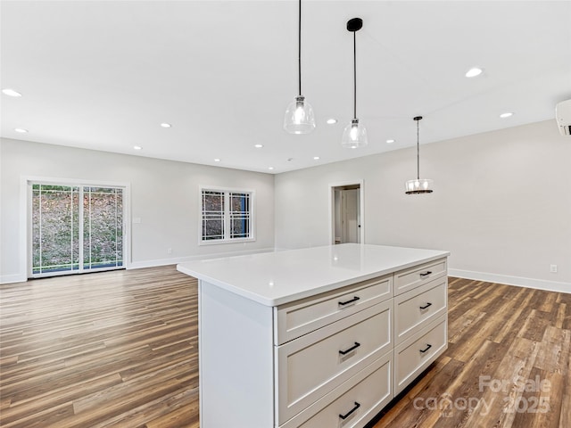 297 Bethany Dr, Mars Hill, NC 28754 - kitchen featuring wood finished floors, open floor plan, a kitchen island, light countertops, and hanging light fixtures