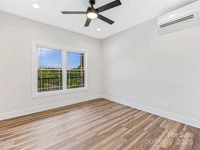 297 Bethany Dr, Mars Hill, NC 28754 - spare room featuring a wall unit AC, light wood-style floors, ceiling fan, and recessed lighting