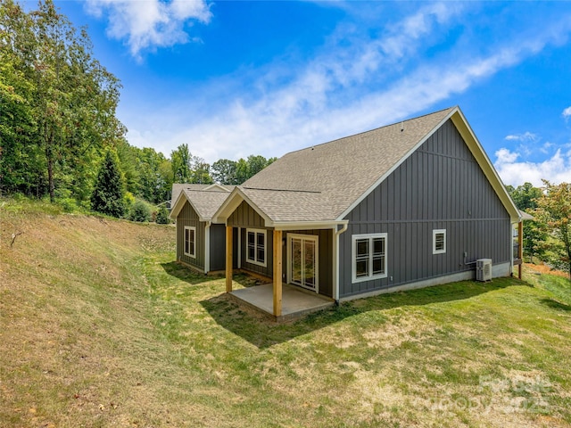 297 Bethany Dr, Mars Hill, NC 28754 - back of property with roof with shingles, a patio, board and batten siding, and a lawn