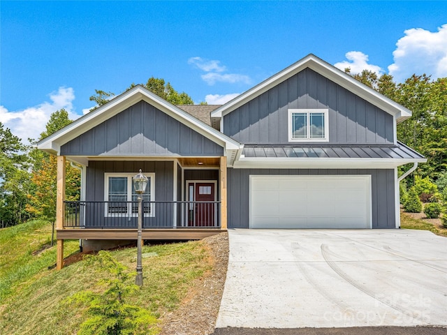 297 Bethany Dr, Mars Hill, NC 28754 - view of front of home featuring a standing seam roof, a garage, driveway, a metal roof, and covered porch