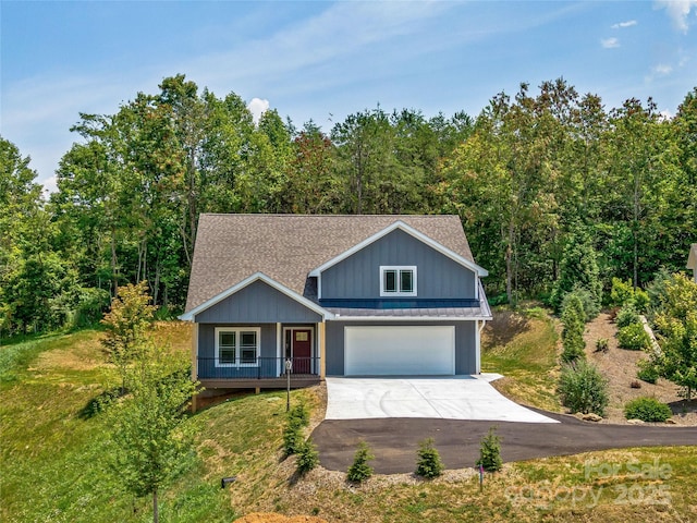 297 Bethany Dr, Mars Hill, NC 28754 - traditional-style home with a porch, concrete driveway, a garage, and roof with shingles