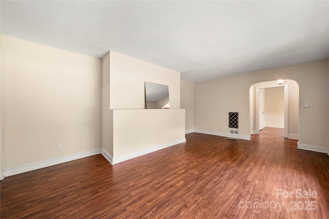 7010 Monroe Rd, Charlotte, NC 28212 - unfurnished living room with wood finished floors and arched walkways