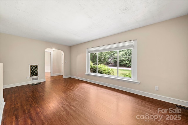 7010 Monroe Rd, Charlotte, NC 28212 - unfurnished living room featuring wood finished floors and arched walkways