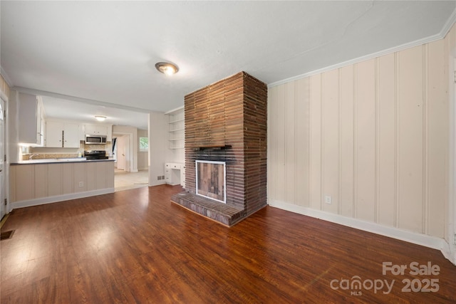 7010 Monroe Rd, Charlotte, NC 28212 - unfurnished living room with wood finished floors and a fireplace