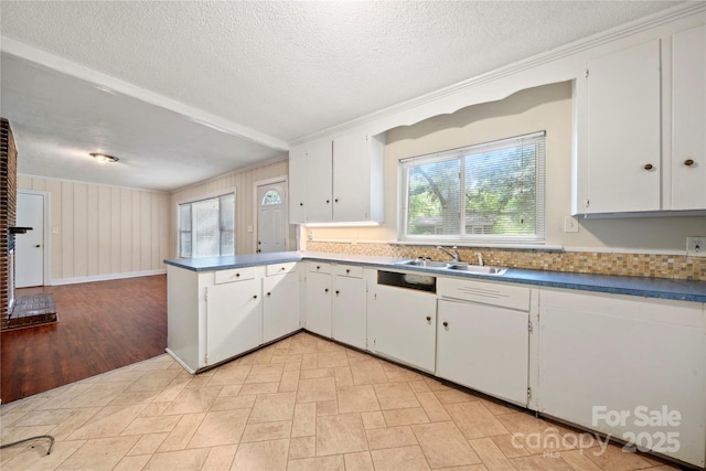 7010 Monroe Rd, Charlotte, NC 28212 - kitchen featuring a peninsula, white cabinets, a textured ceiling, dark countertops, and crown molding