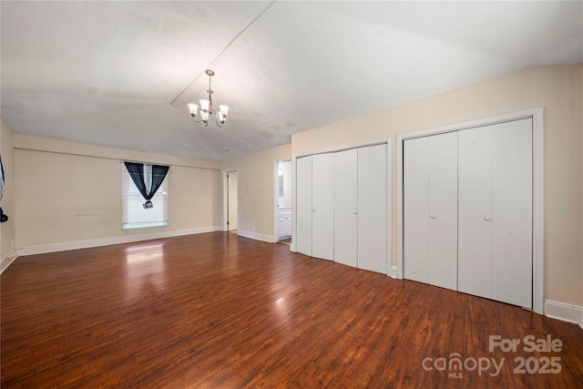 7010 Monroe Rd, Charlotte, NC 28212 - unfurnished bedroom with a chandelier, multiple closets, and wood finished floors
