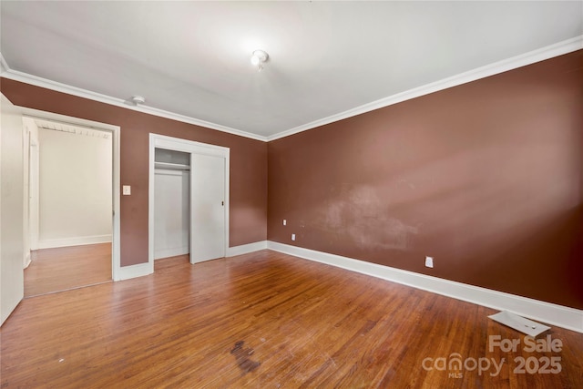 7010 Monroe Rd, Charlotte, NC 28212 - unfurnished bedroom featuring wood finished floors, a closet, and ornamental molding