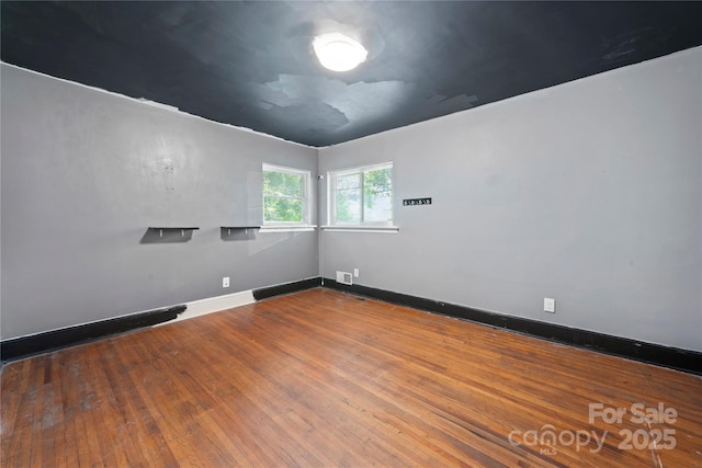 7010 Monroe Rd, Charlotte, NC 28212 - spare room featuring baseboards and wood finished floors