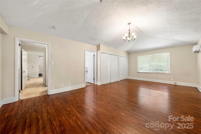 7010 Monroe Rd, Charlotte, NC 28212 - unfurnished bedroom with wood finished floors, a chandelier, and a wall mounted AC