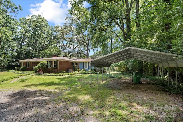 7010 Monroe Rd, Charlotte, NC 28212 - view of grassy yard with a carport and driveway
