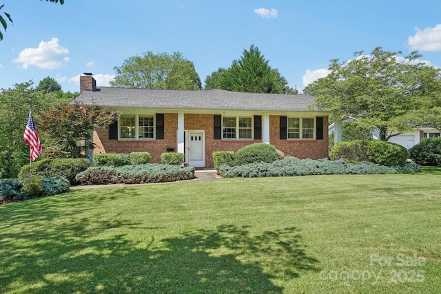 25 Hazel Ct, Brevard, NC 28712 - view of front of home featuring a chimney, a front lawn, and brick siding
