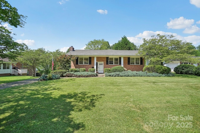 25 Hazel Ct, Brevard, NC 28712 - view of front of home featuring a chimney, a front lawn, and brick siding