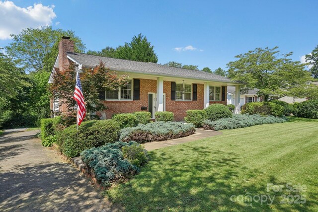 25 Hazel Ct, Brevard, NC 28712 - view of front of property featuring a chimney, brick siding, and a front lawn
