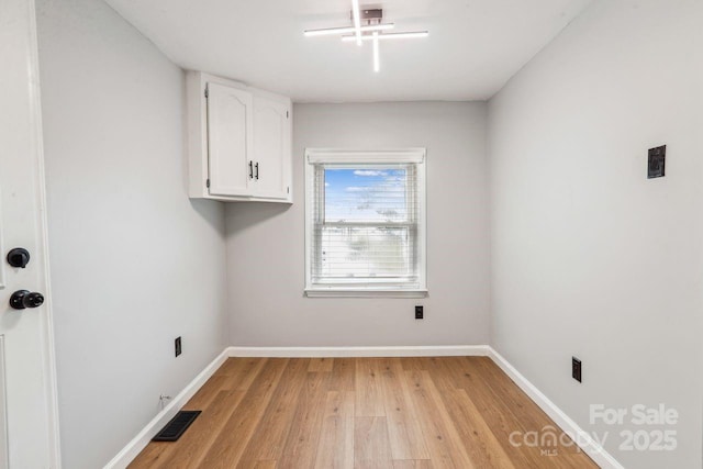 201 Hoyle Cir, Gastonia, NC 28052 - laundry area with cabinet space and light wood-style floors