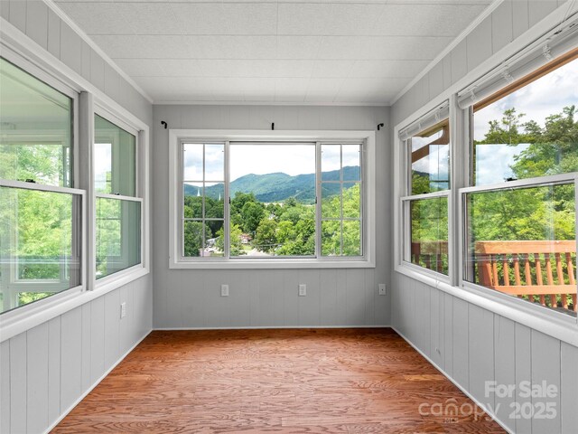 30 Belleview Rd, Waynesville, NC 28786 - unfurnished sunroom with wood finished floors, ornamental molding, a mountain view, and wood walls