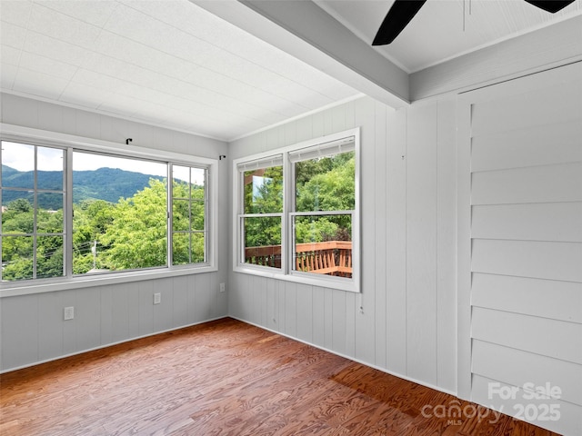 30 Belleview Rd, Waynesville, NC 28786 - empty room with wood finished floors, a ceiling fan, healthy amount of natural light, a mountain view, and crown molding