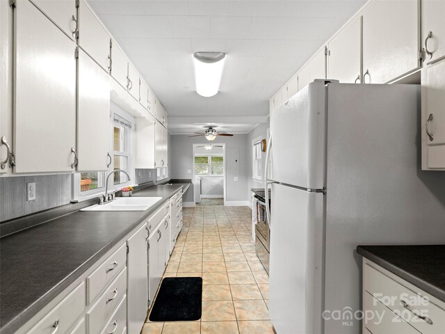30 Belleview Rd, Waynesville, NC 28786 - kitchen with freestanding refrigerator, dark countertops, white cabinetry, and a ceiling fan