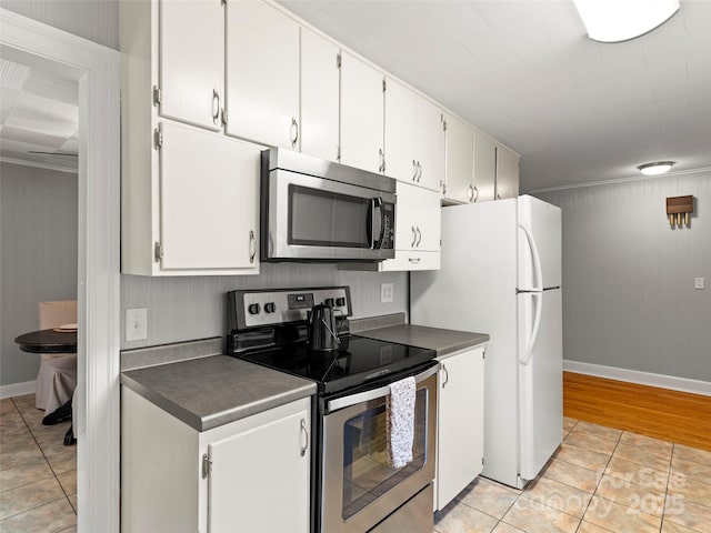 30 Belleview Rd, Waynesville, NC 28786 - kitchen with stainless steel appliances, light tile patterned floors, dark countertops, and white cabinets