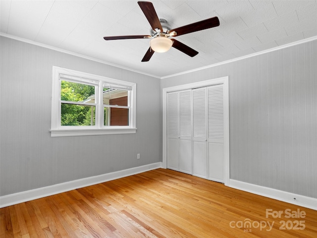 30 Belleview Rd, Waynesville, NC 28786 - unfurnished bedroom with light wood finished floors, crown molding, a closet, and a ceiling fan