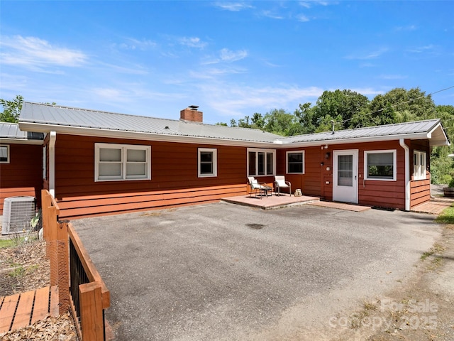 30 Belleview Rd, Waynesville, NC 28786 - rear view of property with a patio, a chimney, and a metal roof