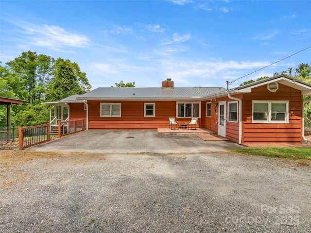 30 Belleview Rd, Waynesville, NC 28786 - view of front of house with a chimney, a metal roof, and a patio
