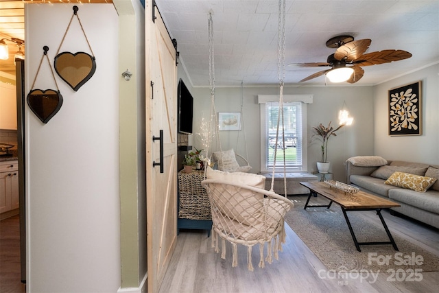1114 Mountain St, Kannapolis, NC 28081 - living room with a barn door, wood finished floors, a ceiling fan, and crown molding
