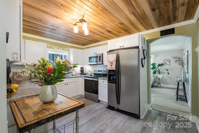 1114 Mountain St, Kannapolis, NC 28081 - kitchen featuring stainless steel appliances, ornamental molding, wooden ceiling, arched walkways, and white cabinets