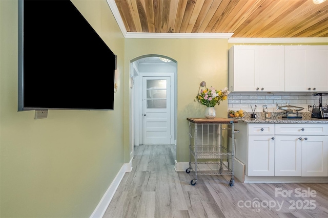 1114 Mountain St, Kannapolis, NC 28081 - kitchen featuring white cabinetry, wooden ceiling, decorative backsplash, arched walkways, and light wood-style floors