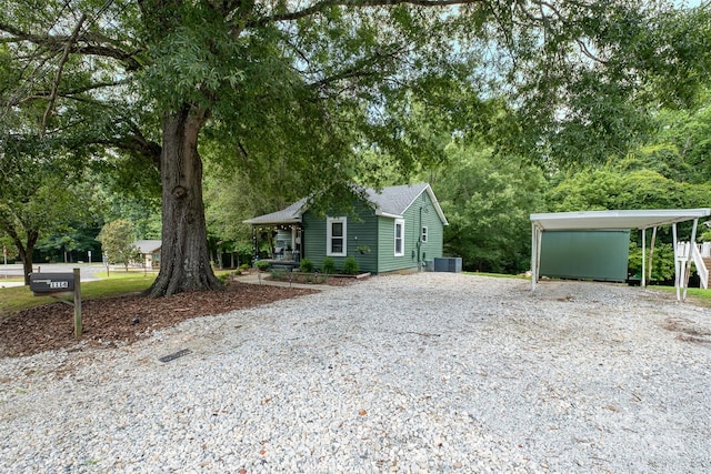 1114 Mountain St, Kannapolis, NC 28081 - view of front of home featuring driveway, roof with shingles, a detached carport, and view of scattered trees