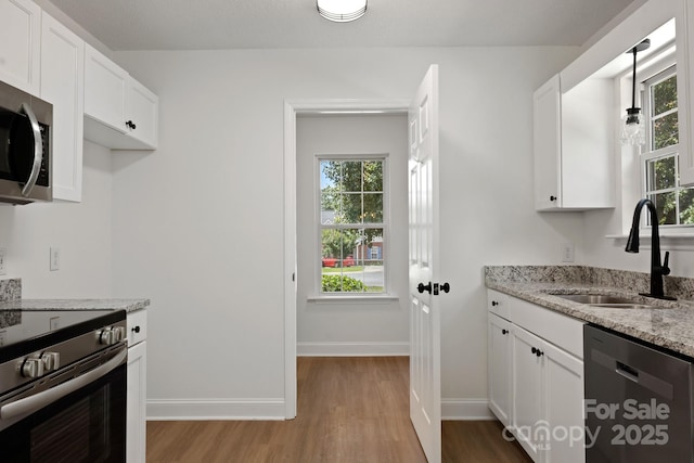 2210 Dawn Rdg, Monroe, NC 28110 - kitchen featuring stainless steel appliances, light wood-style flooring, and plenty of natural light