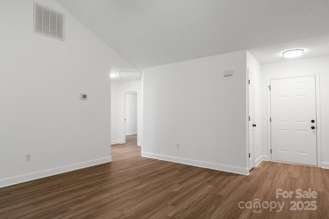 2210 Dawn Rdg, Monroe, NC 28110 - spare room with wood finished floors and lofted ceiling