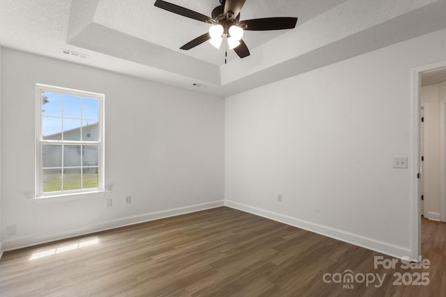2210 Dawn Rdg, Monroe, NC 28110 - empty room featuring a tray ceiling, wood finished floors, and ceiling fan
