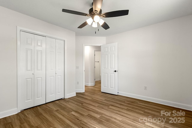 2210 Dawn Rdg, Monroe, NC 28110 - unfurnished bedroom featuring wood finished floors, a closet, and a ceiling fan