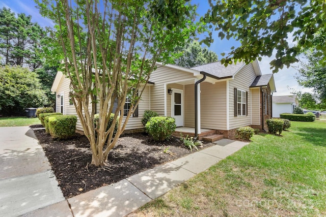 2210 Dawn Rdg, Monroe, NC 28110 - view of front of property featuring covered porch, a front yard, and a shingled roof