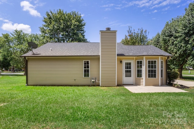 2210 Dawn Rdg, Monroe, NC 28110 - rear view of property featuring a lawn, a patio area, and a chimney