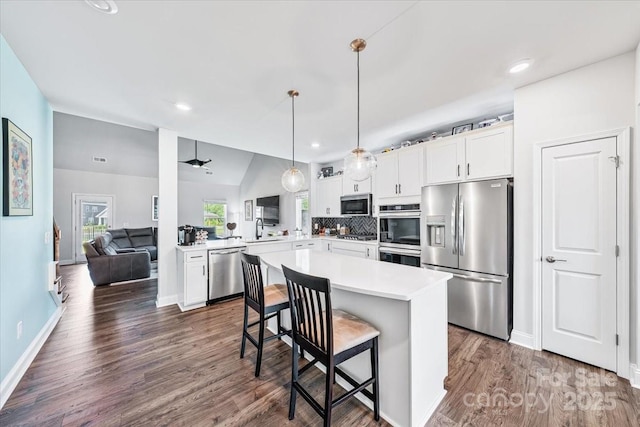 1302 Black Walnut St, Monroe, NC 28112 - kitchen featuring stainless steel appliances, light countertops, a kitchen bar, white cabinets, and recessed lighting