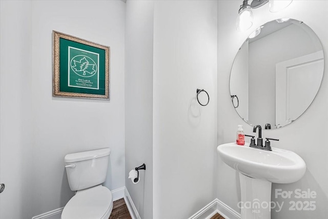 1302 Black Walnut St, Monroe, NC 28112 - half bathroom featuring toilet and wood finished floors