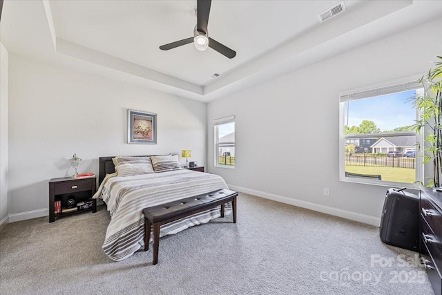 1302 Black Walnut St, Monroe, NC 28112 - carpeted bedroom featuring a tray ceiling and a ceiling fan