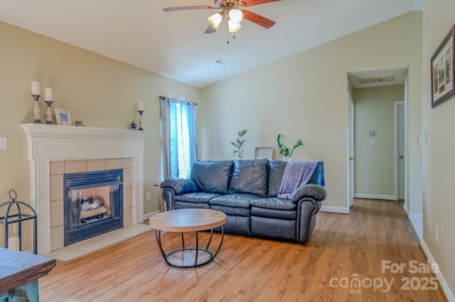 1975 8th Street Ln SE, Hickory, NC 28602 - living area featuring wood finished floors, a ceiling fan, vaulted ceiling, and a fireplace