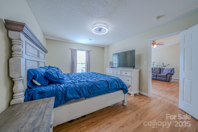 1975 8th Street Ln SE, Hickory, NC 28602 - bedroom with light wood finished floors and a textured ceiling