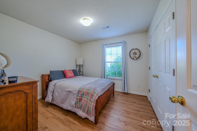 1975 8th Street Ln SE, Hickory, NC 28602 - bedroom with light wood-type flooring and a textured ceiling