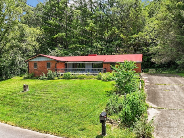 71 Auburn Park Dr, Waynesville, NC 28786 - single story home with a porch, brick siding, a front lawn, and driveway